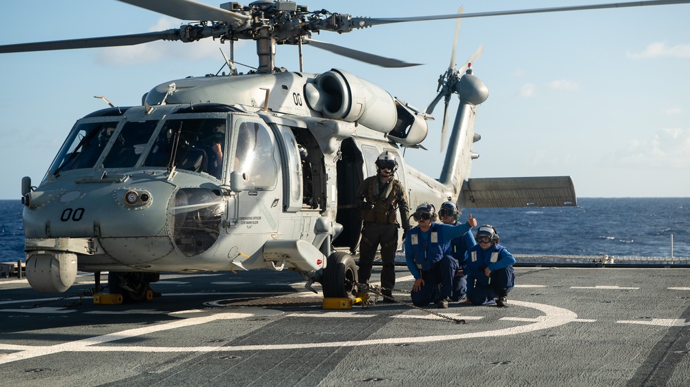 U.S. Coast Guard Cutter Stratton crew train with a Navy MH-60R Seahawk helicopter crew from Andersen Air Force Base on the Pacific Ocean near Guam