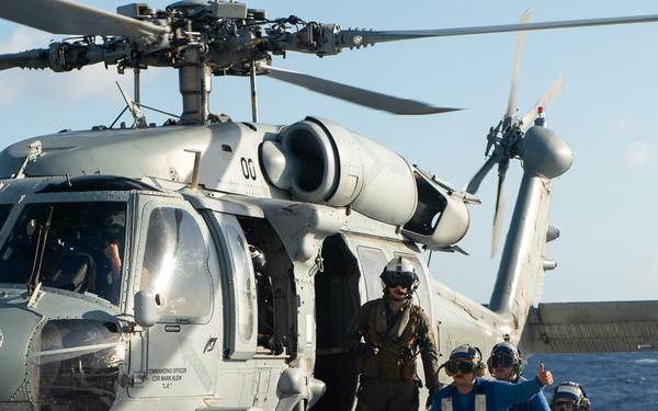U.S. Coast Guard Cutter Stratton crew train with a Navy MH-60S Seahawk helicopter crew from Andersen Air Force Base on the Pacific Ocean near Guam