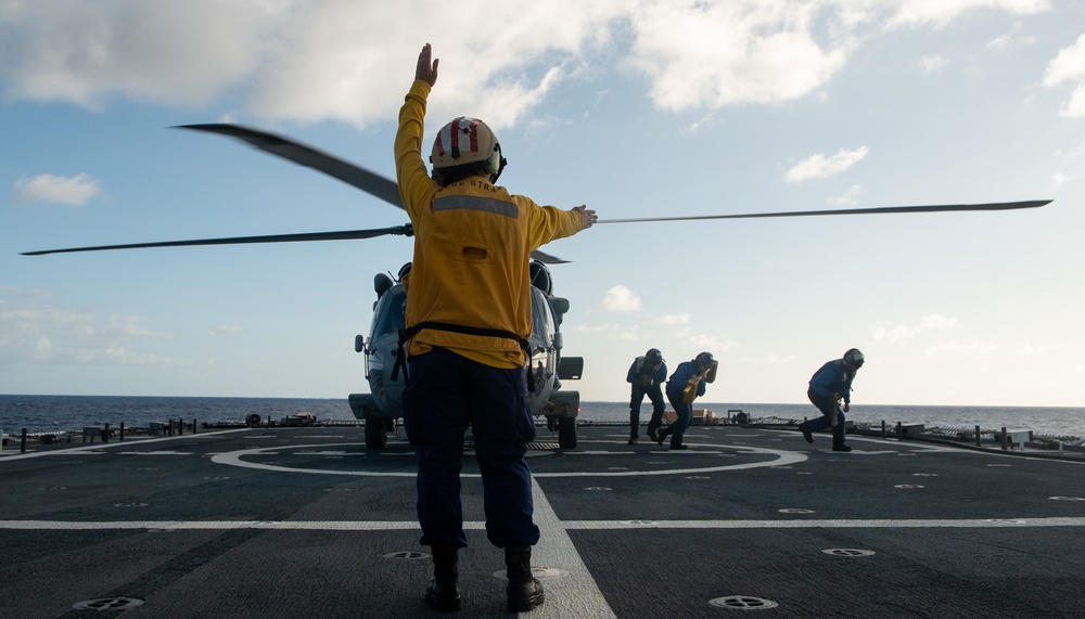 U.S. Coast Guard Cutter Stratton crew train with a Navy MH-60R Seahawk helicopter crew from Andersen Air Force Base on the Pacific Ocean near Guam