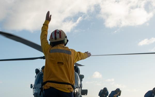 U.S. Coast Guard Cutter Stratton crew train with a Navy MH-60S Seahawk helicopter crew from Andersen Air Force Base on the Pacific Ocean near Guam
