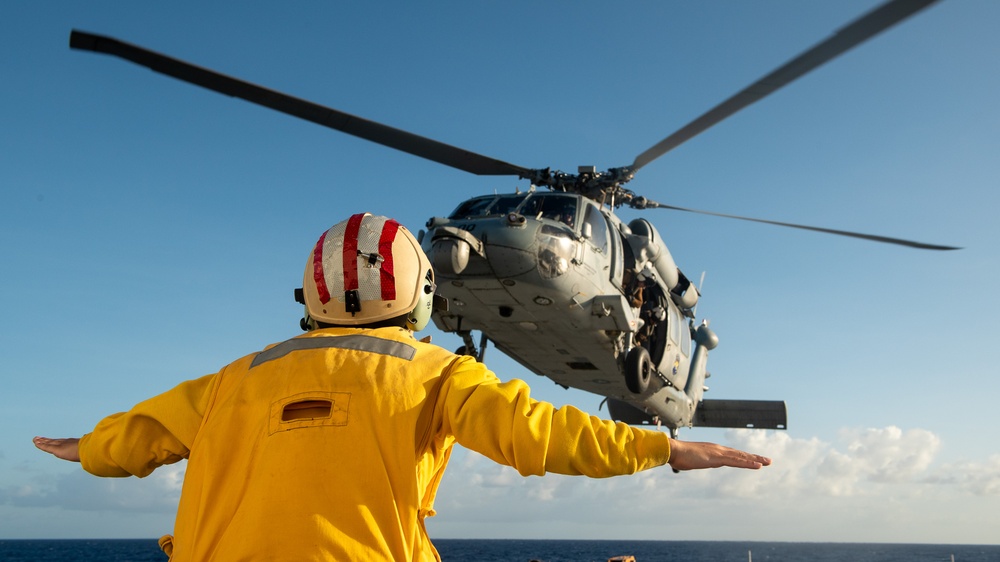 U.S. Coast Guard Cutter Stratton crew train with a Navy MH-60R Seahawk helicopter crew from Andersen Air Force Base on the Pacific Ocean near Guam