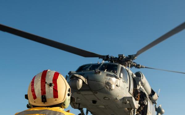 U.S. Coast Guard Cutter Stratton crew train with a Navy MH-60S Seahawk helicopter crew from Andersen Air Force Base on the Pacific Ocean near Guam