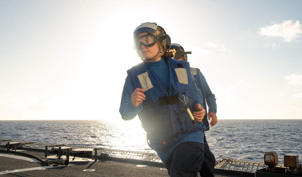 U.S. Coast Guard Cutter Stratton crew train with a Navy MH-60R Seahawk helicopter crew from Andersen Air Force Base on the Pacific Ocean near Guam