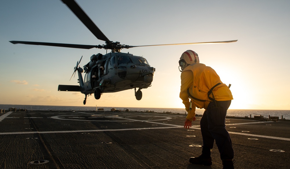 U.S. Coast Guard Cutter Stratton crew train with a Navy MH-60R Seahawk helicopter crew from Andersen Air Force Base on the Pacific Ocean near Guam