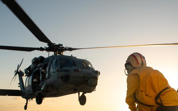 U.S. Coast Guard Cutter Stratton crew train with a Navy MH-60S Seahawk helicopter crew from Andersen Air Force Base on the Pacific Ocean near Guam