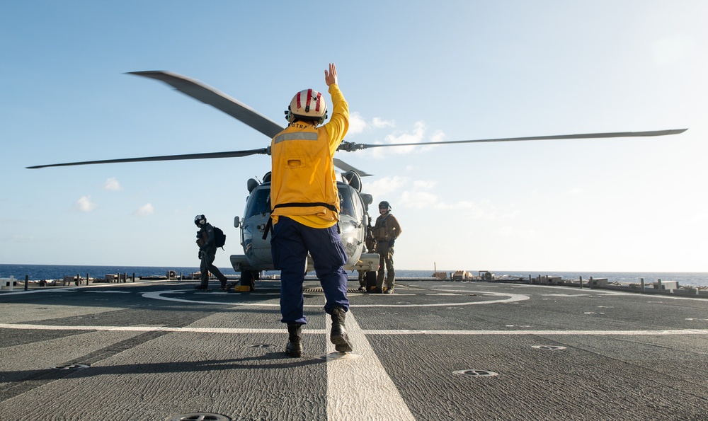 U.S. Coast Guard Cutter Stratton crew train with a Navy MH-60R Seahawk helicopter crew from Andersen Air Force Base on the Pacific Ocean near Guam