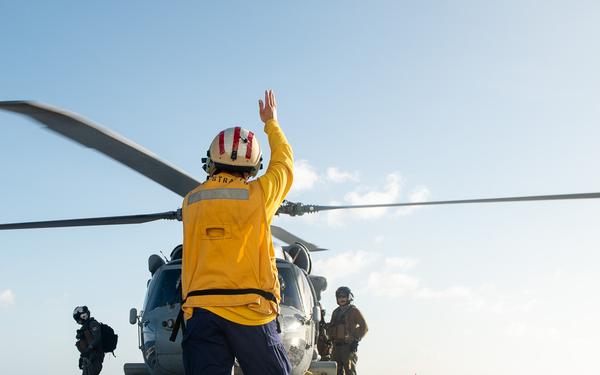 U.S. Coast Guard Cutter Stratton crew train with a Navy MH-60S Seahawk helicopter crew from Andersen Air Force Base on the Pacific Ocean near Guam
