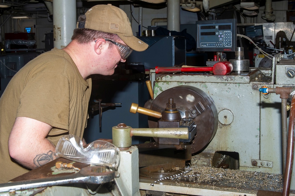 USS Frank Cable Sailor lathing in machine shop