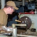 USS Frank Cable Sailor lathing in machine shop