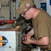 USS Frank Cable Sailor lathing in machine shop