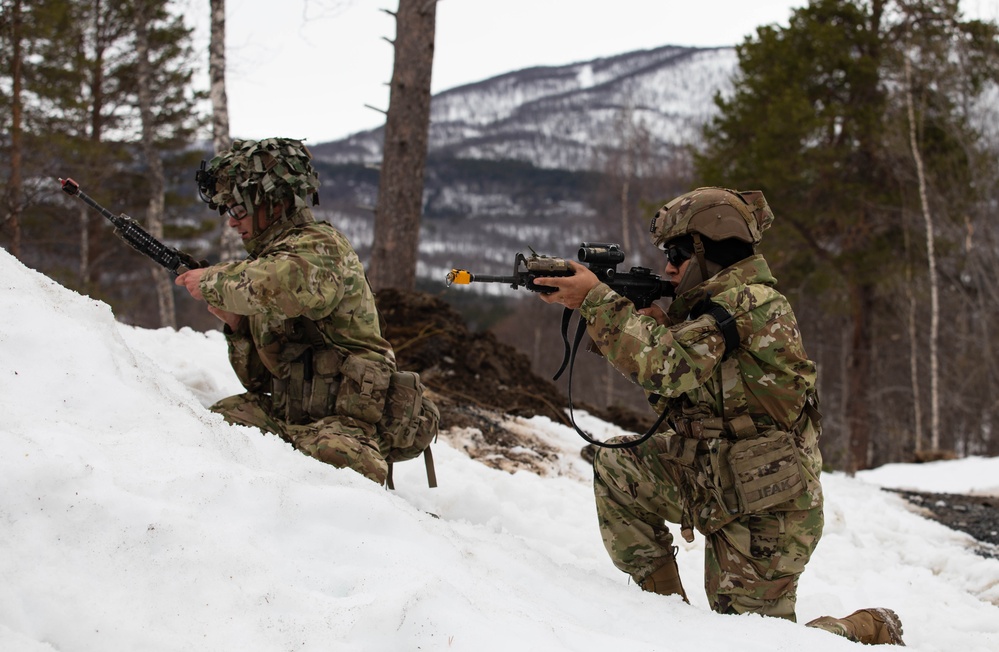 A Paratrooper from the 2nd Battalion, 505th Parachute Infantry Regiment, 3rd Brigade Combat Team, 82nd Airborne Division, lays down cover fire while his teammate reloads his weapon, May 15, 2025 in Setermoen, Norway.