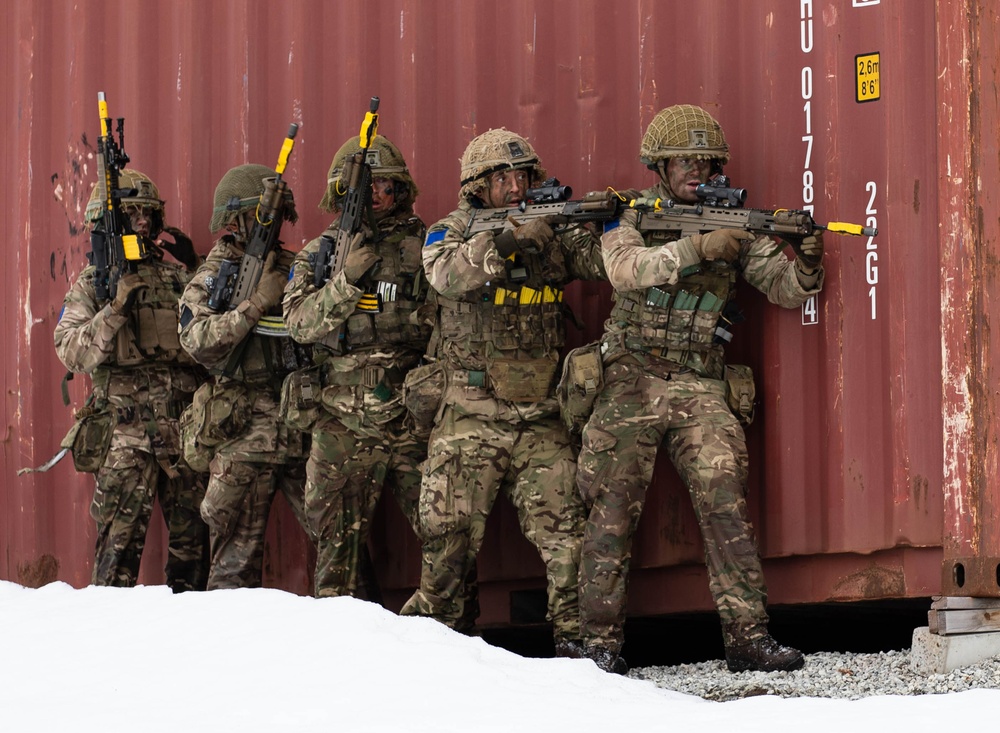 British troops form a stack behind cover and prepare to engage an opposing force during Swift Response