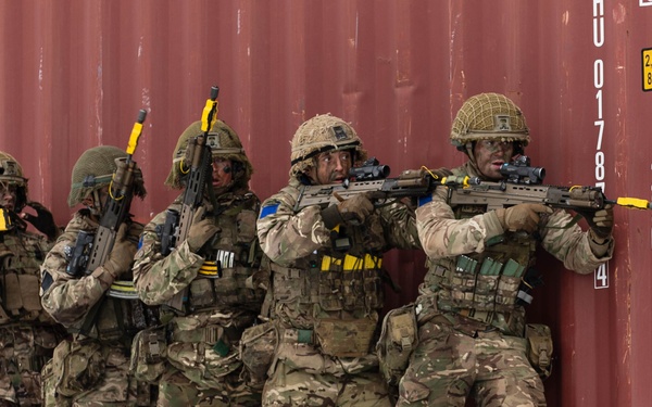 British troops form a stack behind cover and prepare to engage an opposing force during Swift Response