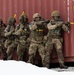 British troops form a stack behind cover and prepare to engage an opposing force as part of a joint training exercise with U.S., Norwegian and Hungarian soldiers, May 15, 2025 in Setermoen, Norway.