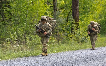 Competitors complete ruck march during V Corps Best Squad Competition