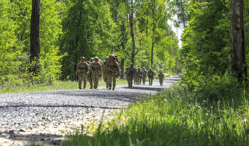 Competitors complete ruck march during V Corps Best Squad Competition
