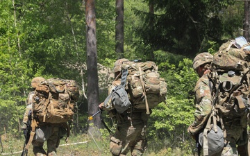 Competitors complete ruck march during V Corps Best Squad Competition