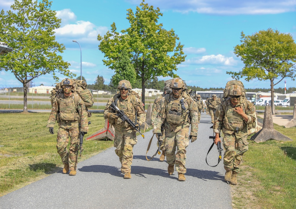 Competitors complete ruck march during V Corps Best Squad Competition