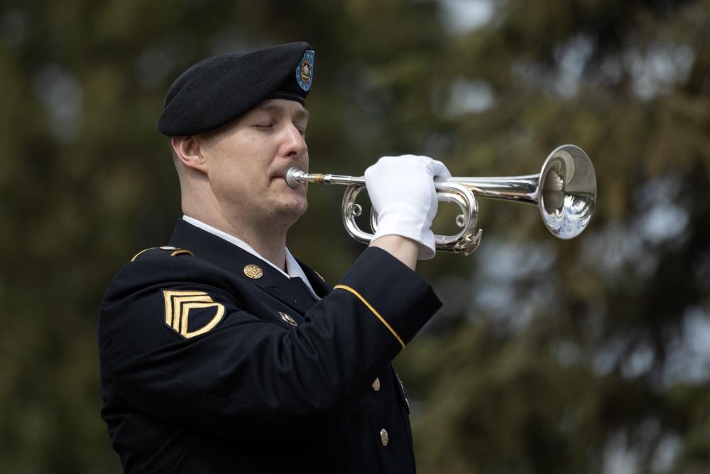 Alaska Army National Guardsman plays Taps during memorial service