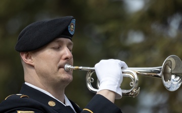 Alaska Army National Guardsman plays Taps during memorial service