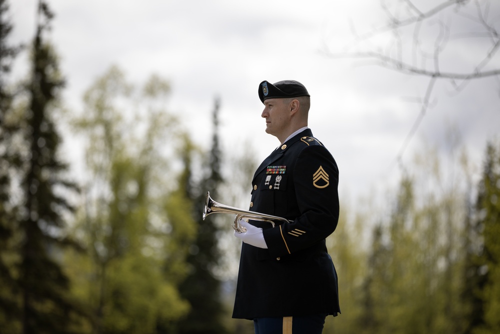 Alaska Army National Guardsman plays Taps during memorial service