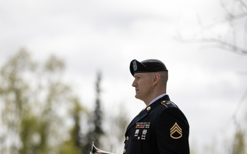 Alaska Army National Guardsman plays Taps during memorial service
