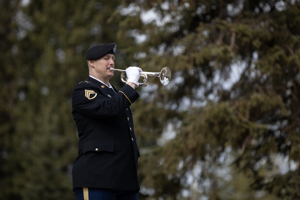 Alaska Army National Guardsman plays Taps during memorial service