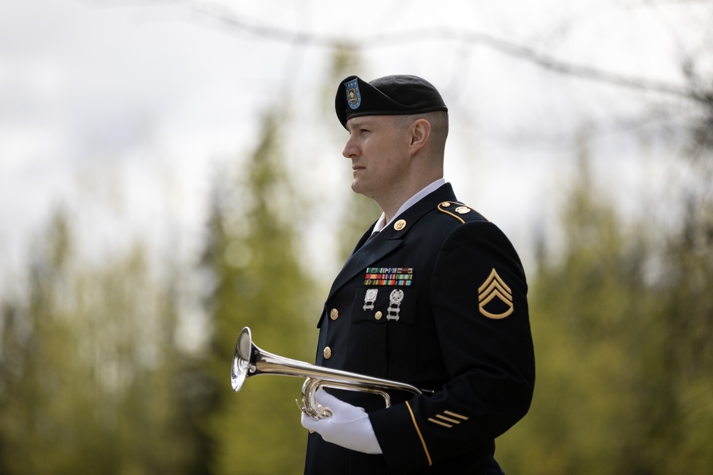 Alaska Army National Guardsman plays Taps during memorial service