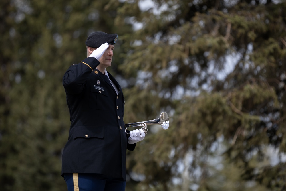 Alaska Army National Guardsman plays Taps during memorial service