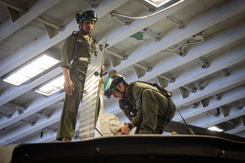 Marines Conduct Aircraft Maintenance On USS Iwo Jima
