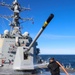 Boatswain’s Mate 1st Class Ethan Elks conduct a fresh water wash down on the fo’c’sle