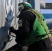 Aviation Technician 2nd Class Carlos Sanchez Mercado conducts a pre-flight check