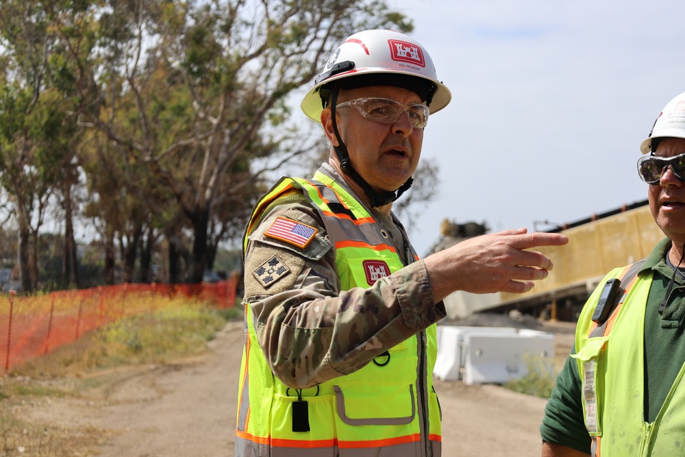 Col. Palazzini speaks to a reporter about the Temporary Debris Staging and Reduction area
