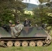 Opposing forces return simulated fire from a return fire from a M113 armored personnel carrier