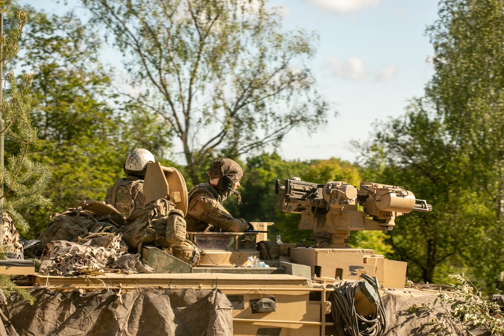 Soldiers maneuver a Bradley A3 for simulated assault