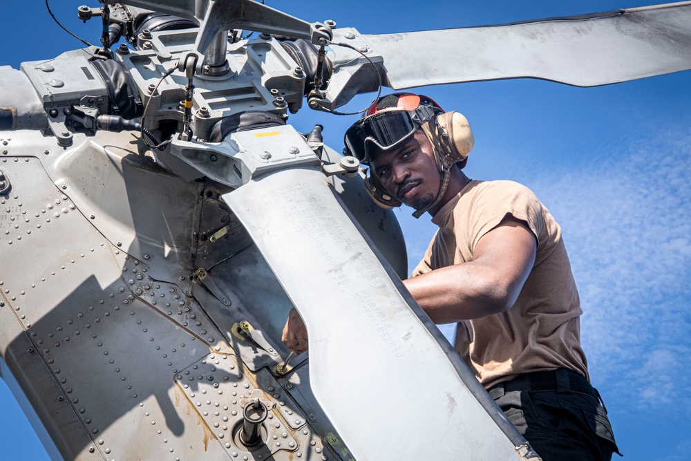 Nimitz Sailor Performs Pre-Flight Inspection on a Helicopter