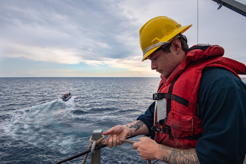Sailor Observes Boat Operations