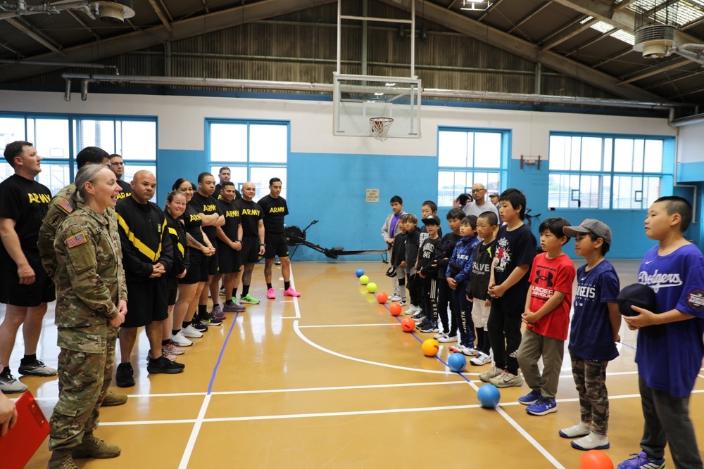 Capt. Alena Leshchyk, left, commander of the 5th Transportation Company commander, along with Soldiers from her unit, welcome the Yokohama Higashi Little League team to an inaugural sports exchange event May 6 at Yokohama North Dock.