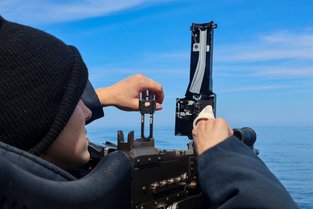 Gunner’s Mate Seaman Trinity Anderson performs a routine maintenance check on the starboard bridge wing M240 machine gun