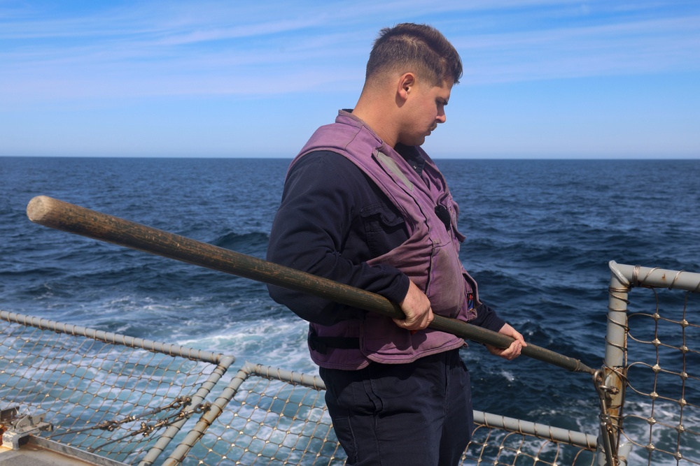 Gas Turbine Systems Technician (Mechanical) 2nd Class Robert Capps lowers the aft flight deck safety nets