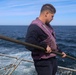Gas Turbine Systems Technician (Mechanical) 2nd Class Robert Capps lowers the aft flight deck safety nets