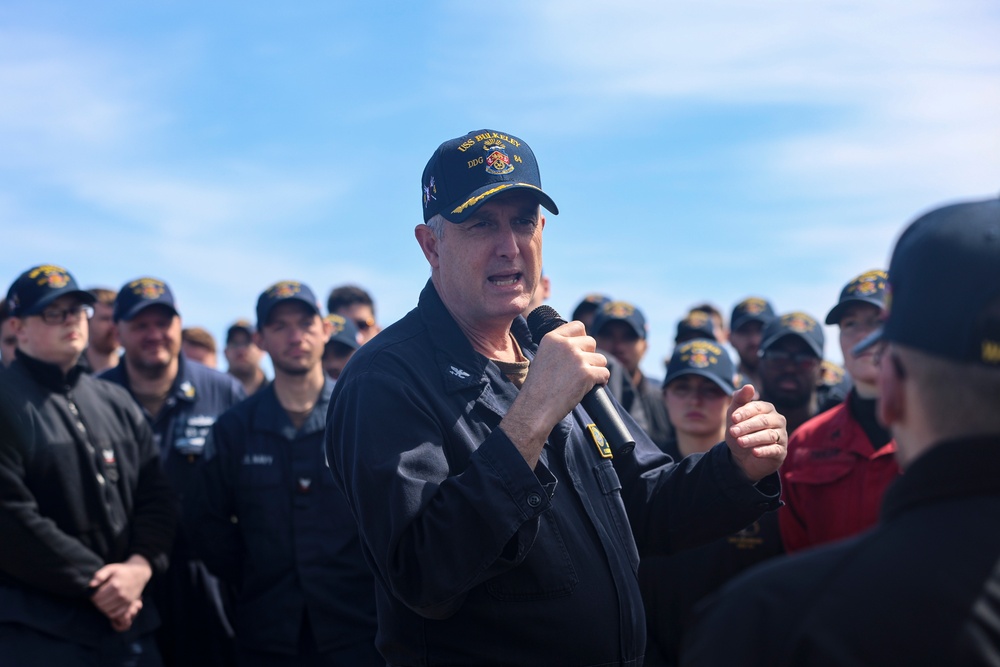 Capt. Michael Dwan, commodore, Combined Task Force (CTF) 64 delivers remarks to the crew of the USS Bulkeley (DDG 84)