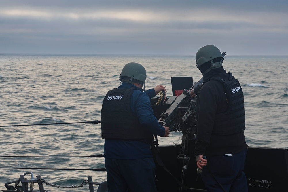Command Master Chief Sergio Gonzalez loads a M2A1 50-caliber gun