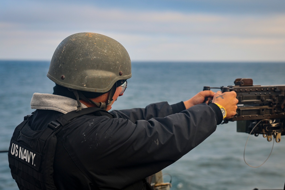 Gunner’s Mate 2nd Class Joshua Cvitic fires an M2A1 50-caliber gun