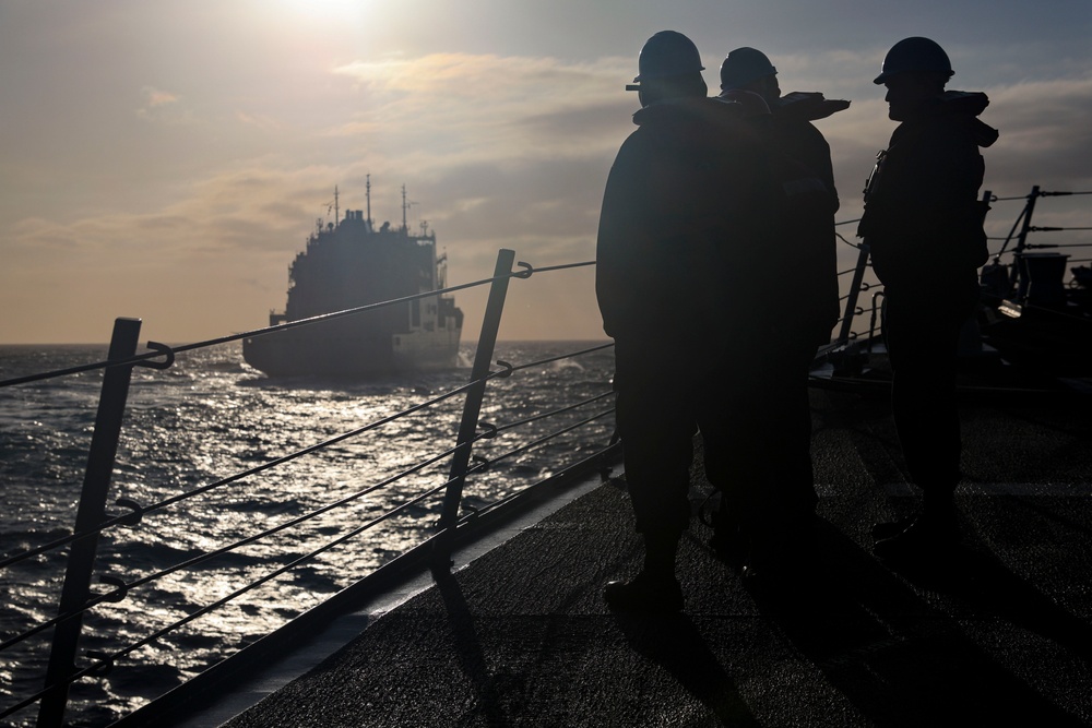 U.S. Navy Sailors muster on the fo’c’sle in preparation for a replenishment-at-sea