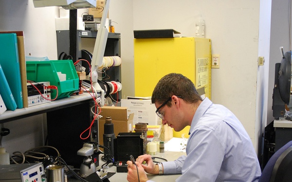 AFRL/RW scientist working in an electronics lab.