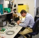 AFRL/RW scientist working in an electronics lab.