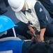 Boatswain’s Mate 3rd Class Carlens Milice connect the pelican and surf hooks on the sliding padeye