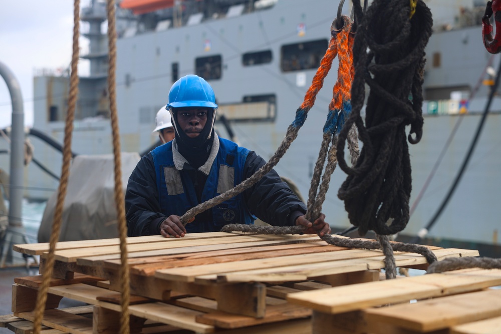 Boatswain’s Mate 3rd Class Carlens Milice secures empty pallets for return to the USNS William McLean (T-AKE 12)