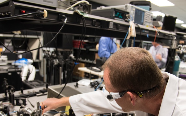 AFRL/RW scientist works on an experiment in a photonics laboratory